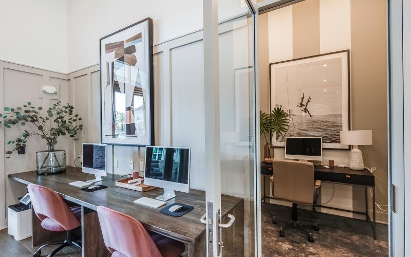 a room with a desk and computer