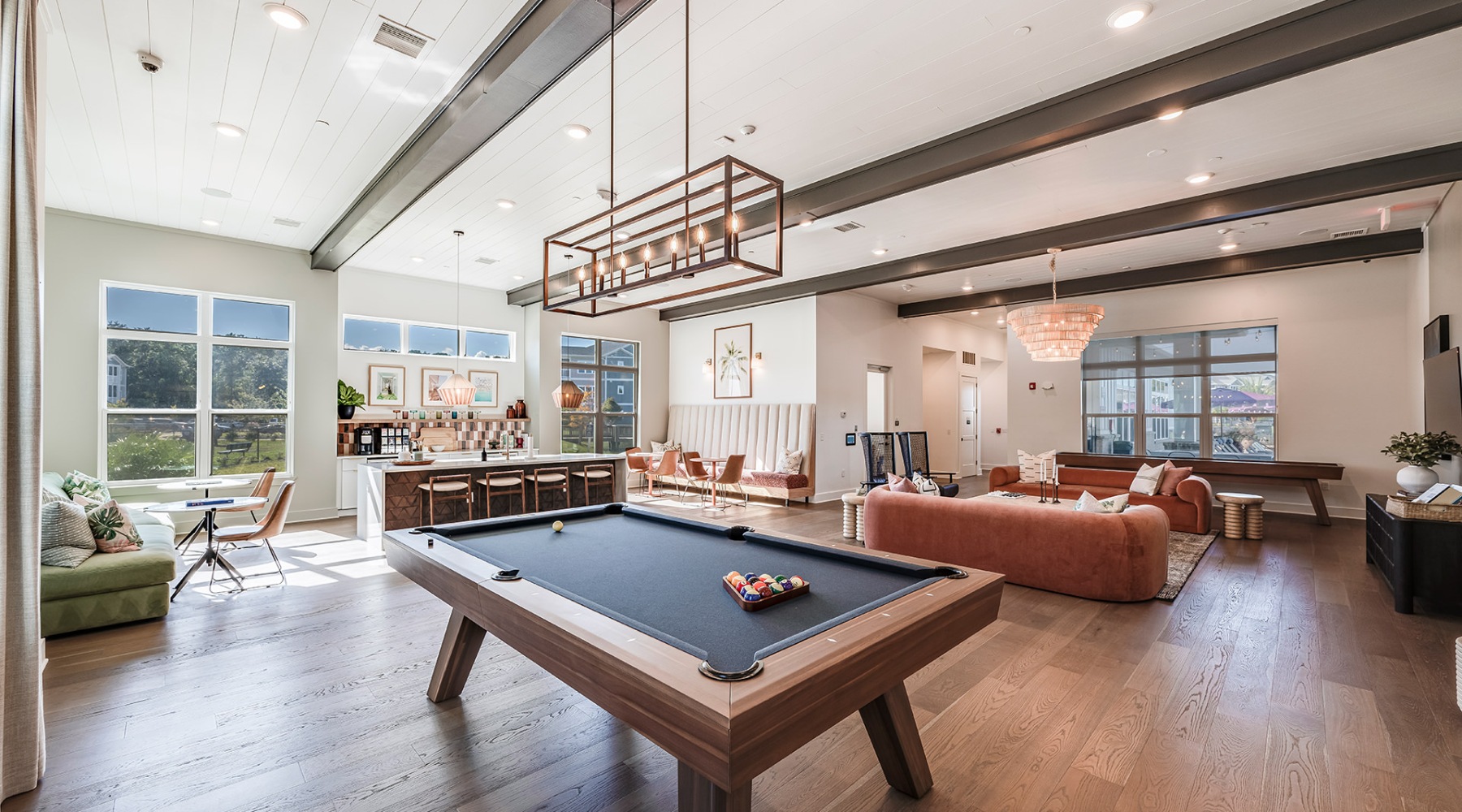 a large room with a pool table and couches